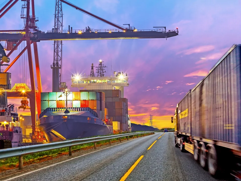 Cargo ship, cranes and a freight truck in JDA's corporate supply-chain imagery